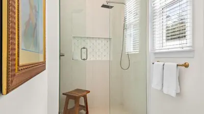 a shower with a glass door in a bathroom at Crow's Nest in Santa Rosa Beach