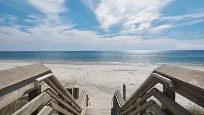 a staircase leading to a beach with the ocean at Cassine Station 302 in Santa Rosa Beach