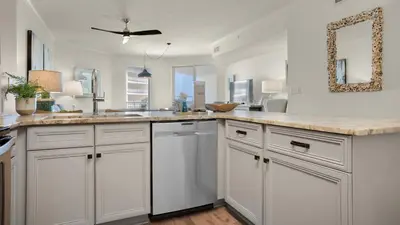 a kitchen with white cabinets and a counter top at Dunes Of Seagrove 201B in Santa Rosa Beach