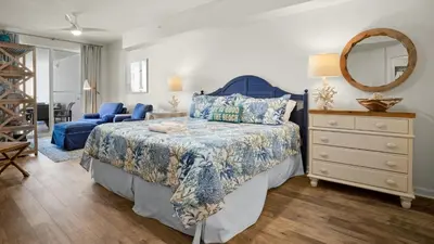 a bedroom with a bed and a dresser and a mirror at Dunes Of Seagrove 201B in Santa Rosa Beach