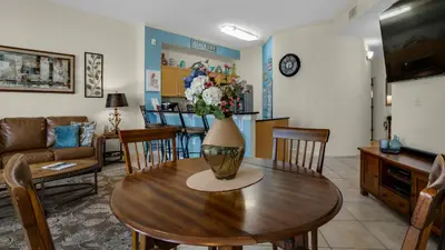 a living room with a table with a vase of flowers on it at Dunes Of Seagrove 202C in Santa Rosa Beach