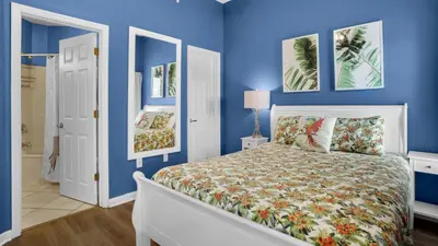 a bedroom with blue walls and a white bed at Dunes Of Seagrove 202C in Santa Rosa Beach