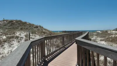 a wooden boardwalk leading to the beach at Dunes Of Seagrove 202C in Santa Rosa Beach