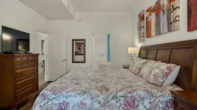 a bedroom with a bed and a dresser and a television at Dunes Of Seagrove 202C in Santa Rosa Beach