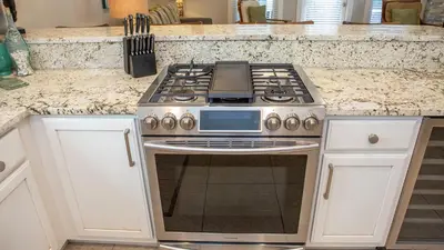 a kitchen with a stove and a counter top at Dolphin House in Santa Rosa Beach