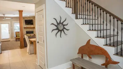 a home with a staircase with a spider on the wall at Dolphin House in Santa Rosa Beach