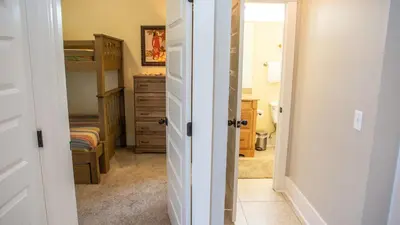 a bathroom with a bedroom with a bed and a closet at Dolphin House in Santa Rosa Beach