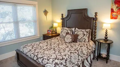 a bedroom with a large bed and a window at Dolphin House in Santa Rosa Beach