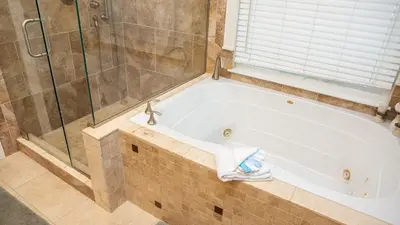 a white bath tub in a bathroom with a shower at Dolphin House in Santa Rosa Beach