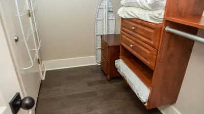 a room with a dresser and a bed with a mirror at Dolphin House in Santa Rosa Beach