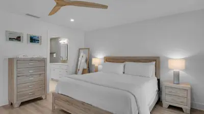 a bedroom with a large white bed and two night stands at Dune Villas 3B in Santa Rosa Beach