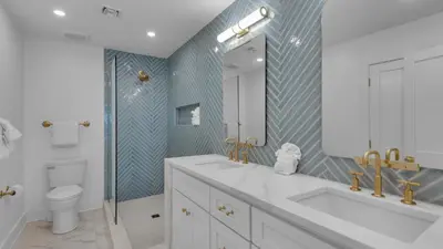 a bathroom with a sink and a toilet and a mirror at Dune Villas 3B in Santa Rosa Beach