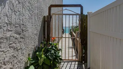an open gate with a door to a beach at Dune Villas 3B in Santa Rosa Beach