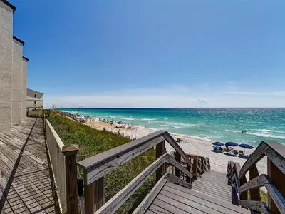 a view of the beach from a wooden stairway at Dune Villas 3B in Santa Rosa Beach