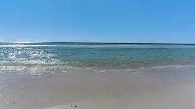 a sandy beach with the ocean in the background at Emerald Hill 1 in Santa Rosa Beach
