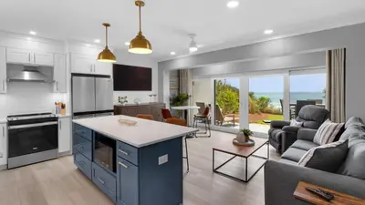 an open kitchen and living room with a view of the ocean at Emerald Hill 1 in Santa Rosa Beach