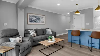 a living room with a couch and a kitchen at Emerald Hill 1 in Santa Rosa Beach