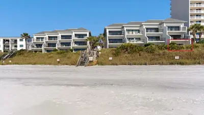a building on the beach next to the water at Emerald Hill 1 in Santa Rosa Beach