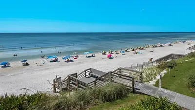 a beach with a bunch of people and the ocean at Emerald Hill 6 in Santa Rosa Beach