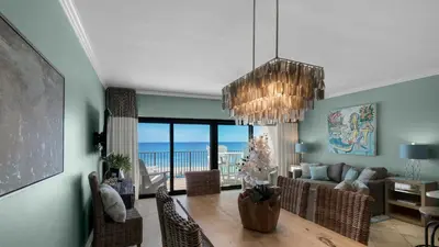 a dining room with a dining table with a view of the ocean at Emerald Hill 6 in Santa Rosa Beach