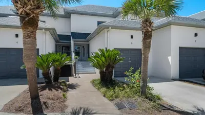 a house with palm trees in front of it at Emerald Hill 6 in Santa Rosa Beach