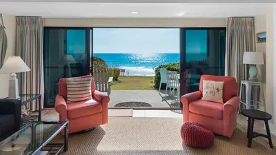 a living room with two chairs and a view of the ocean at Emerald Hill 9 in Santa Rosa Beach