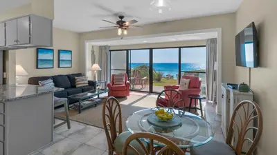 a kitchen and living room with a table and chairs at Emerald Hill 9 in Santa Rosa Beach
