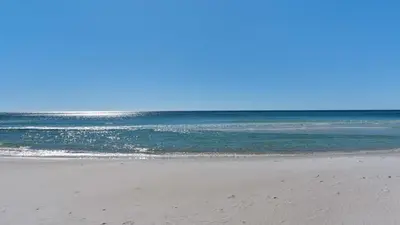 a sandy beach with the ocean in the background at Emerald Hill 11 in Santa Rosa Beach