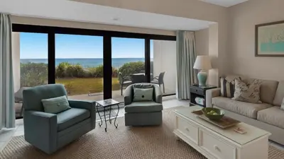 a living room with a couch and chairs and a large window at Emerald Hill 11 in Santa Rosa Beach