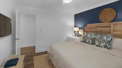 a bedroom with a bed and a flat screen tv at Eastern Shores 201 - A Happy Little Condo in Santa Rosa Beach
