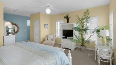 a bedroom with a bed and a tv in it at Float Away in Panama City Beach