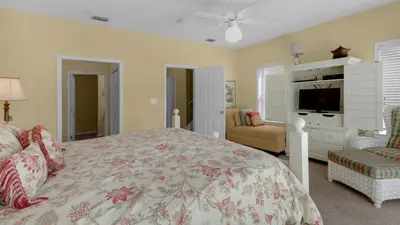a bedroom with a large bed and a television at Float Away in Panama City Beach