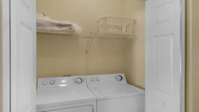 a kitchen with a white stove and a dishwasher at Float Away in Panama City Beach