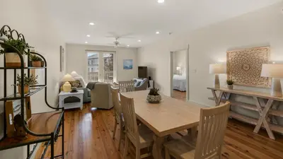 a dining room and living room with a table and chairs at Grand Isle 202 in Santa Rosa Beach