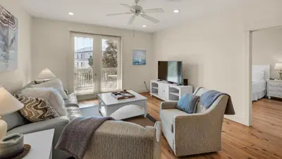 a living room with two chairs and a tv at Grand Isle 202 in Santa Rosa Beach