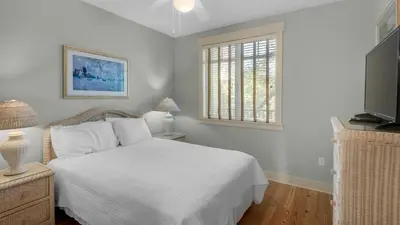 a bedroom with a white bed and a window at Grand Isle 202 in Santa Rosa Beach