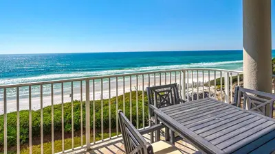 a table and chairs on a balcony overlooking the beach at Tranquillity 340 in Panama City Beach