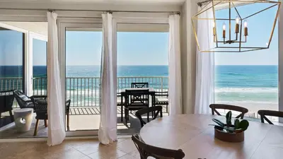 a dining room with a view of the ocean at Tranquillity 340 in Panama City Beach