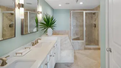 a bathroom with two sinks and a shower at Tranquillity 340 in Panama City Beach