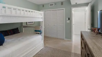 a bedroom with a bunk bed and a closet at Tranquillity 340 in Panama City Beach