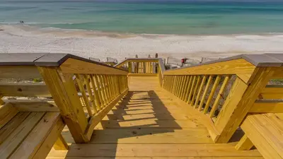 a wooden staircase leading to a beach with the ocean at Tranquillity 340 in Panama City Beach