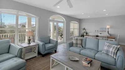 a living room with two blue couches and a table at Villas At Seagrove B201 - Emerald Dunes in Santa Rosa Beach
