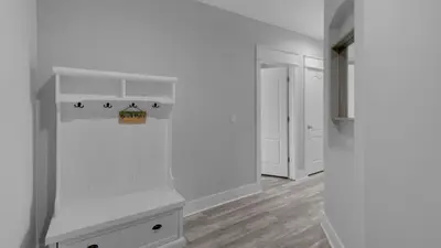 a white room with a counter and a hallway at Villas At Seagrove B201 - Emerald Dunes in Santa Rosa Beach