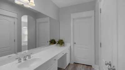 a white bathroom with a sink and a mirror at Villas At Seagrove B201 - Emerald Dunes in Santa Rosa Beach