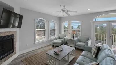 a living room with a couch and chairs and a fireplace at Villas At Seagrove B201 - Emerald Dunes in Santa Rosa Beach