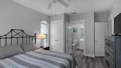 a bedroom with a bed and a bathroom at Villas At Seagrove B201 - Emerald Dunes in Santa Rosa Beach