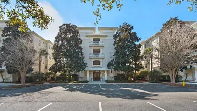 a large building with a parking lot in front of it at Villas At Seagrove C401 in Santa Rosa Beach