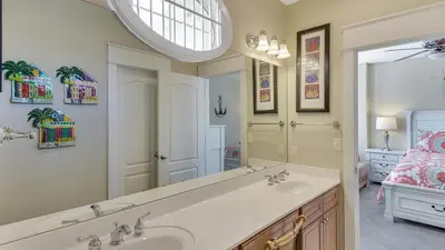 a bathroom with a sink and a large mirror at Villas At Seagrove C401 in Santa Rosa Beach