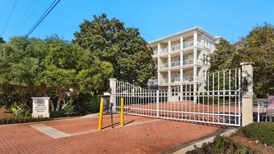 a white gate in front of a building at Villas At Seagrove C401 in Santa Rosa Beach