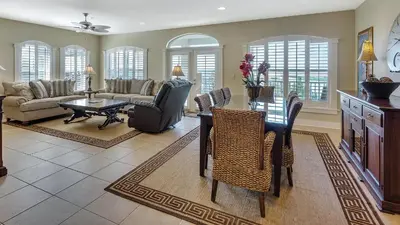 a living room with a table and chairs and a couch at Villas At Seagrove C401 in Santa Rosa Beach